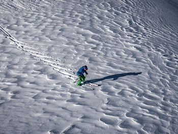 High angle view of person skiing on snow covered field