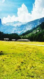 Scenic view of field and mountains against sky