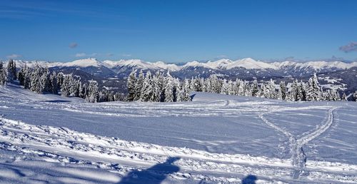 Snow covered landscape against sky