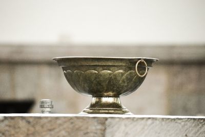 Close-up of wineglass on table against wall