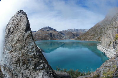 Scenic view of lake and mountains against sky