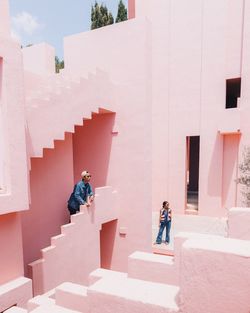 People on staircase outside building