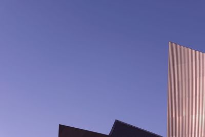 Low angle view of buildings against blue sky