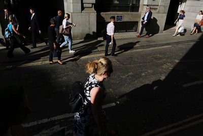 High angle view of people walking on street in city