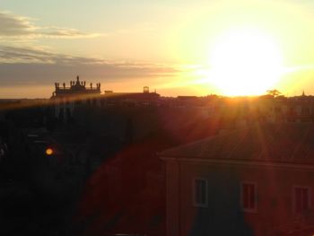 Scenic view of city against sky during sunset