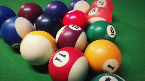 Close-up of pool balls on green table