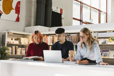 Young people studying in library