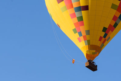 Low angle view of hot air balloon against clear blue sky