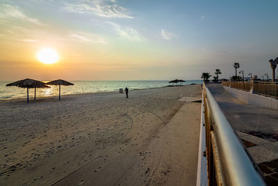 Scenic view of beach against sky during sunset