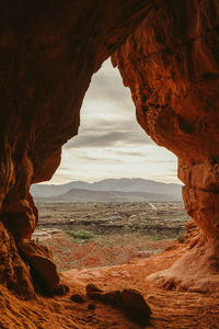 Looking out at the town of st. george utah from a large cave entrance