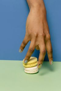 Low section of woman against blue wall