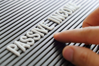 Close-up of hand with text on patterned surface