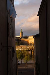 Buildings in city against sky during sunset