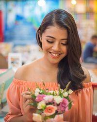 Close-up of beautiful young woman holding flower