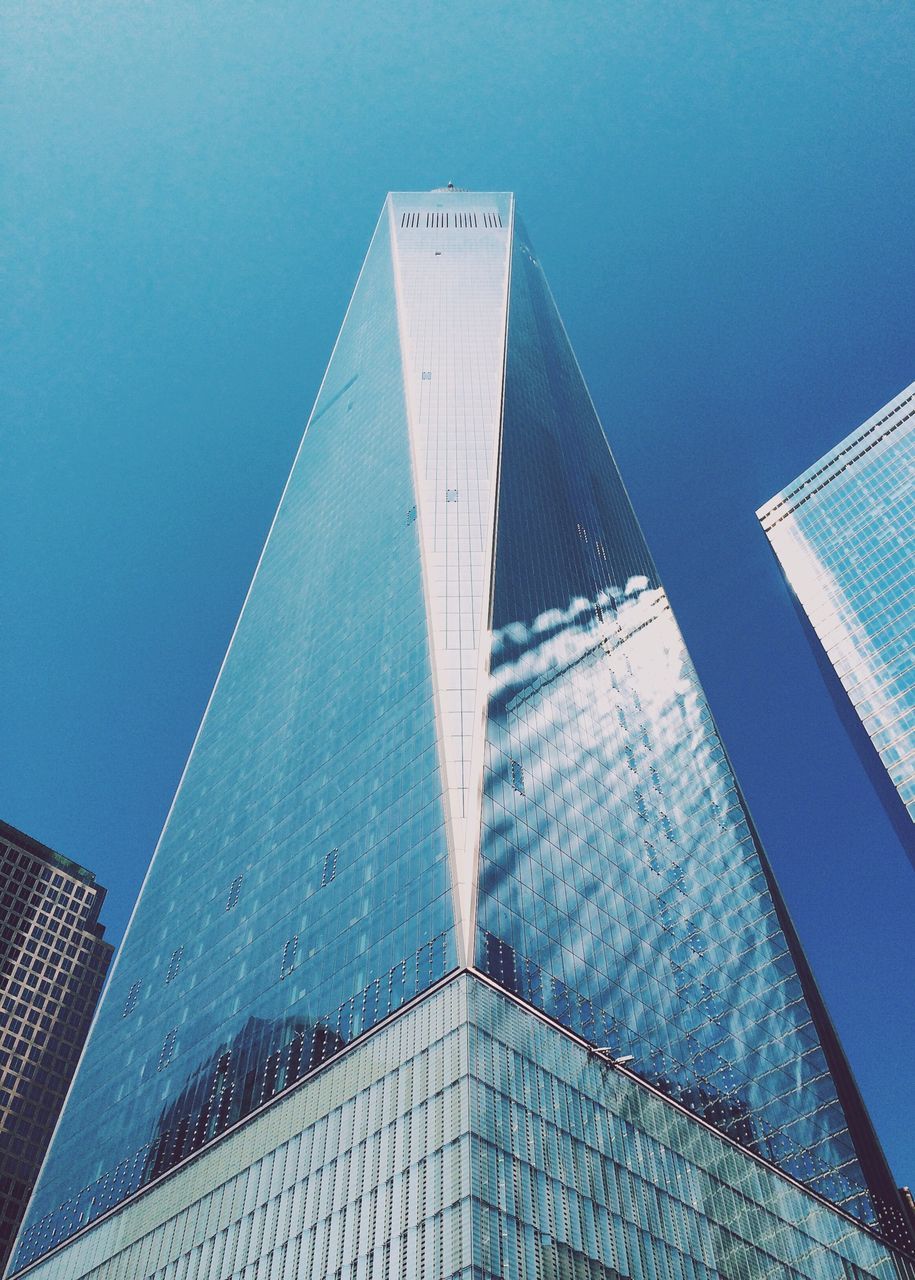 architecture, built structure, building exterior, modern, skyscraper, low angle view, office building, city, tall - high, blue, tower, glass - material, building, clear sky, sky, reflection, capital cities, day, outdoors, no people