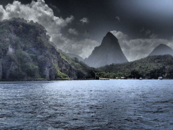 Scenic view of sea and mountains against sky