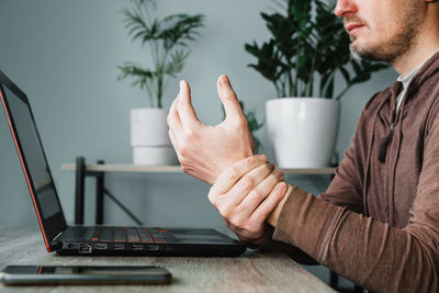 A man suffering from numbness in his hand and wrist, arthritis and occupational disease