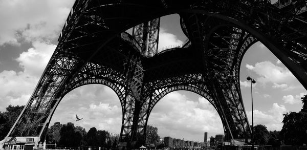 Low angle view of bridge against cloudy sky