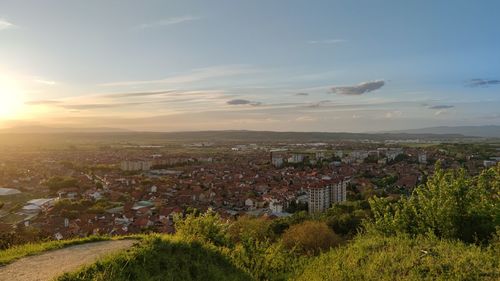 Aerial view of townscape against sky at sunset