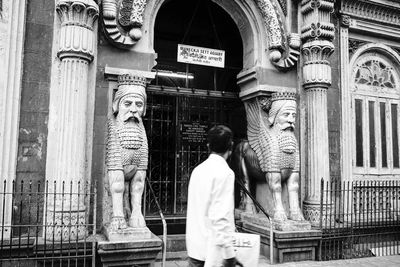 Statue of buddha against building