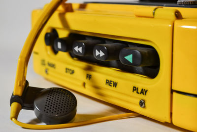 Close-up of yellow telephone on table