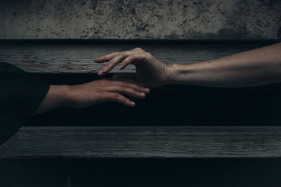 Midsection of man with hands on table