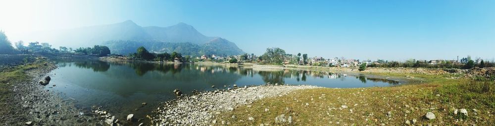 Scenic view of lake and mountains against sky