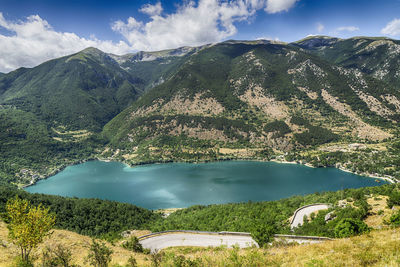 Scenic view of lake and mountains against sky