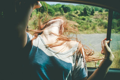 Woman looking through window