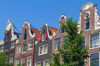 Low angle view of buildings against blue sky