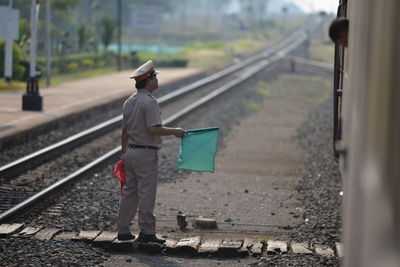 Man standing on railroad track