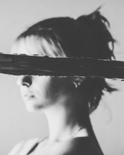 Close-up portrait of woman holding leaf