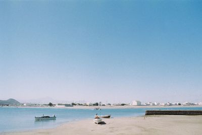 Scenic view of sea against clear blue sky