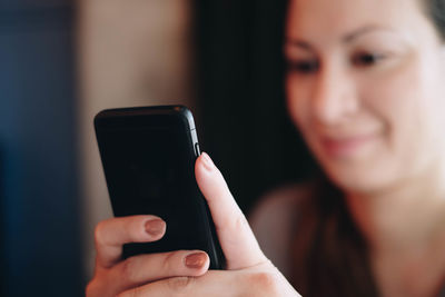 Midsection of woman using mobile phone