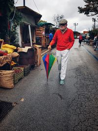 Man standing on road against buildings