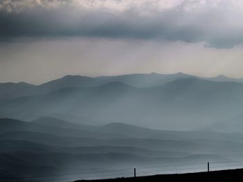 Scenic view of mountains against sky at dusk