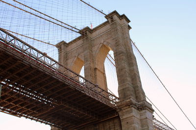 Low angle view of brooklyn bridge against clear sky