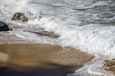 Waves splashing on rocks at shore