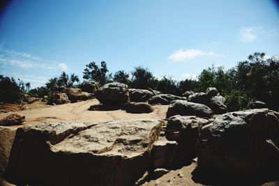 Rocks on landscape against sky