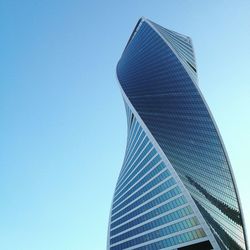 Low angle view of evolution tower against clear blue sky