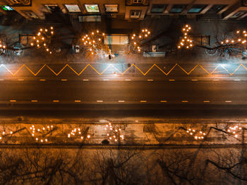 Illuminated street light against sky at night