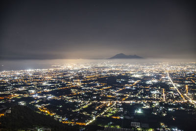 High angle view of illuminated buildings in city at night