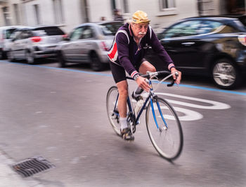 Man riding bicycle on city street