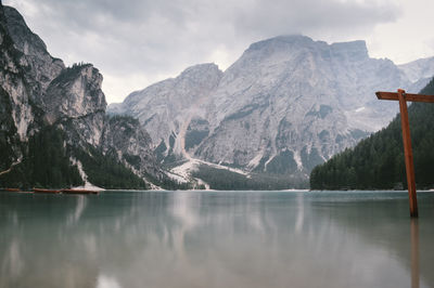 Scenic view of lake by mountains against sky