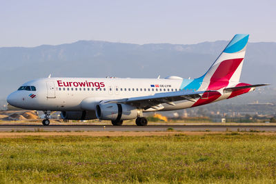 Airplane on runway against sky