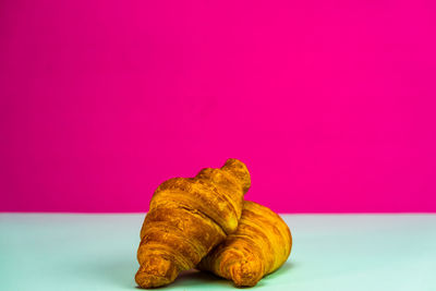 Close-up of chocolate on table against pink background