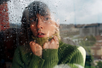 Close-up portrait of raindrops on glass window