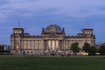 Facade of historical building in city at dusk