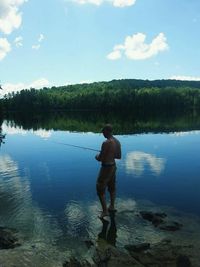 Woman standing by lake