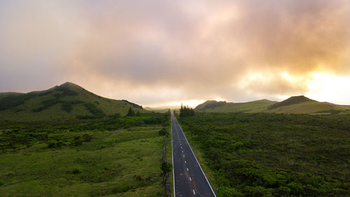 Road passing through mountains against sky